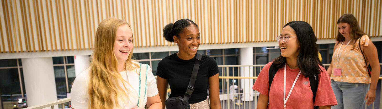 Four students walk in the new Morgridge Hall